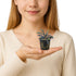 Person holding a small potted plant Bucephalandra Red Catherine in their hand against a plain background